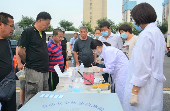 圖為檢測技術(shù)人員現(xiàn)場為市民檢快檢鮮牛肉.