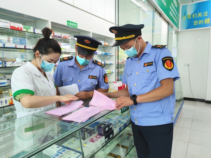 圖為監(jiān)管人員在一家藥店檢查。