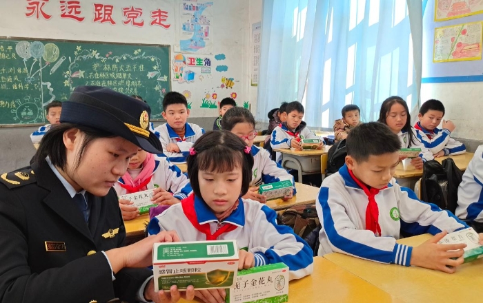 圖為工作人員在嶺背鎮(zhèn)中心小學向同學們講解藥品安全知識。