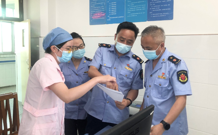 圖為城固縣市場監(jiān)管局執(zhí)法人員查驗疫苗、檢測試劑相關(guān)資質(zhì)和冷鏈記錄。