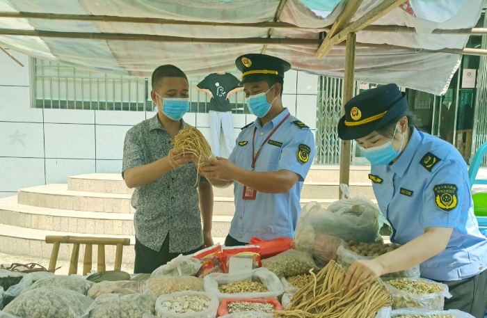 圖為8月3日，該局執(zhí)法人員在一處鄉(xiāng)鎮(zhèn)集市中藥材攤位檢查在售藥材質(zhì)量。